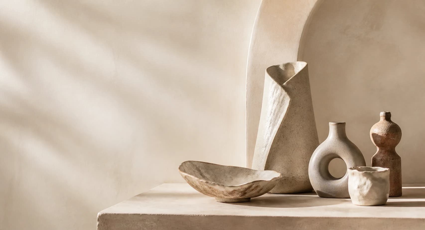 Custom handmade ceramic pieces in a warm studio